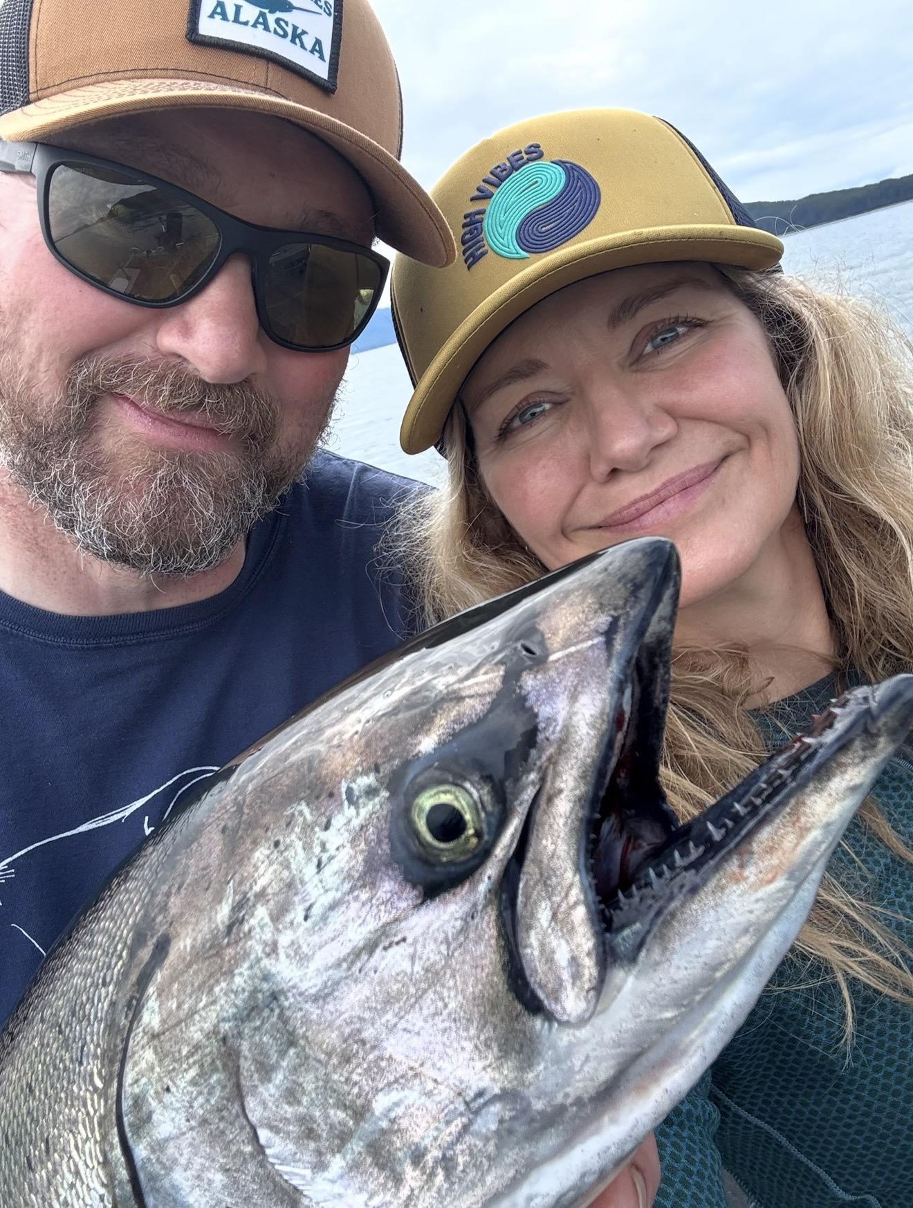 Captain Alan and Tanja of Adventures in Alaska, the premier fishing captain team in Juneau, Alaska, standing on the deck of their boat.